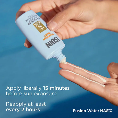 Hand applying Fusion Water MAGIC sunscreen cream to palm with blue background